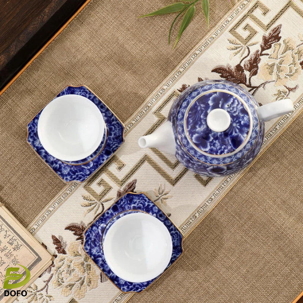 Blue and white old ice plum, one pot and two cups with coasters