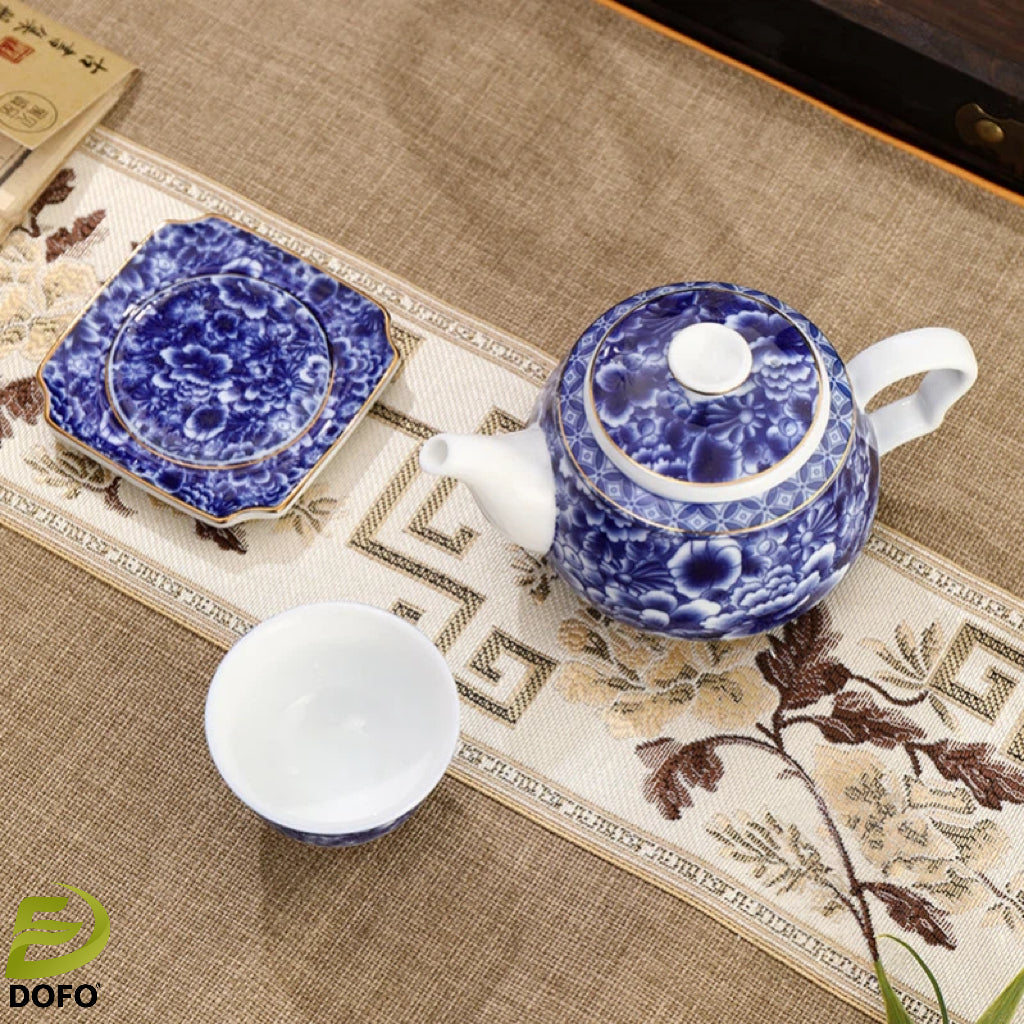 Blue and white old ice plum, one pot and two cups with coasters